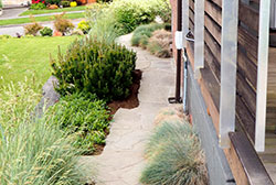 The side garden, too narrow for fencing (that would obstruct views as well), is fun with a zig-zag to the paving and low, soft grasses and perennials. The side garden, too narrow for fencing (that would obstruct views as well), is fun with a zig-zag to the paving and low, soft grasses and perennials.