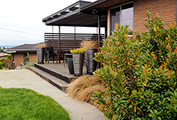 The patio and plants in back compliment the deck and dining area. The patio and plants in back compliment the deck and dining area.