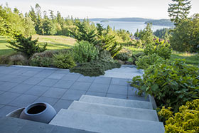 View down past the Sunning Terrace to the coastal meadow and out to the bay.